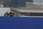 Radio Le Mans has become (certainly for me) one of THE absolutely essential aspects of the Le Mans race each each.  Here we see the RLM commentary booth up in the main ACO grandstand, overlooking the start-finish straight.  RLM supremo John Hindhaugh (stripey top) prepares for the off.